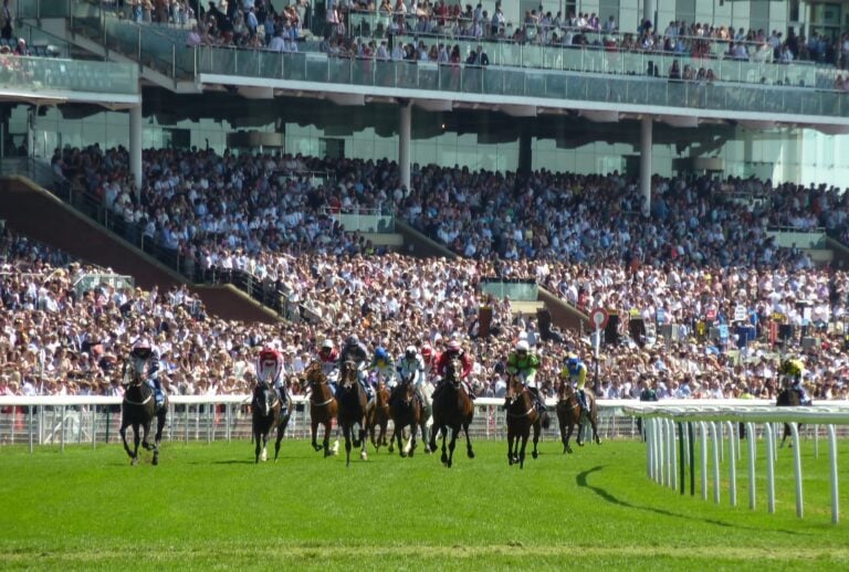 Horses Racing Around The Track