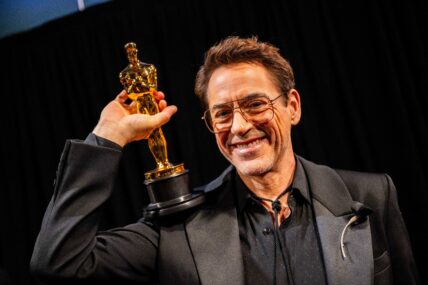 Robert Downey Jr. holding his Oscar trophy