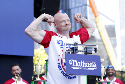 Nick Wehry stands on the scale at the 108th Nathan's Famous Fourth of July International Hot Dog Eating Contest