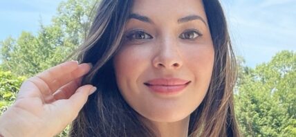 Olivia Munn smiles outdoors