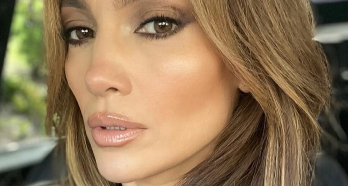Jennifer Lopez poses in a car