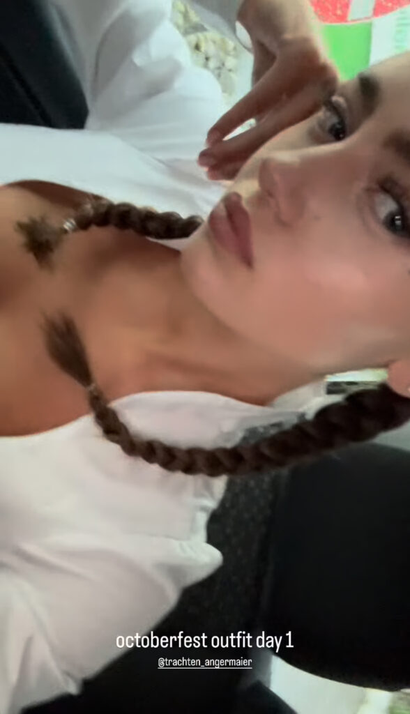 Leni Klum takes a video to show off her outfit.