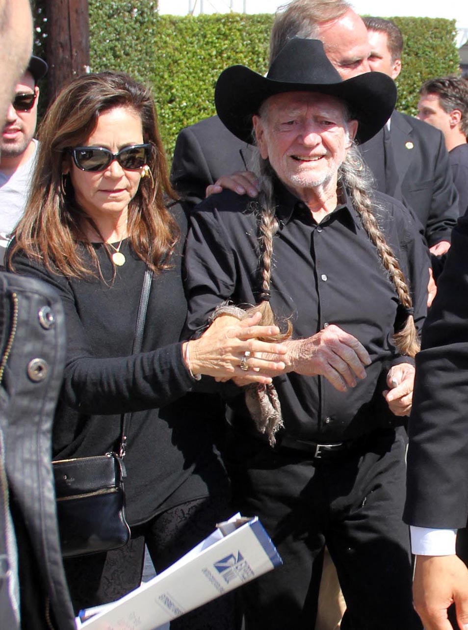 Willie Nelson wearing a black cowboy hat