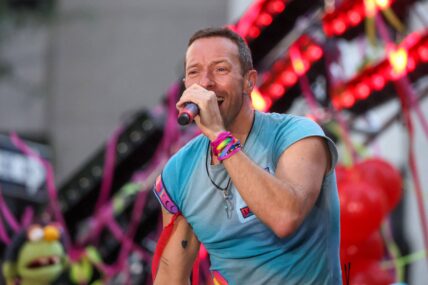Vocalist Chris Martin along with his band Coldplay during a performance on a television show at Rockefeller Plaza in New York City