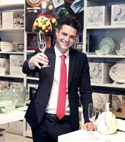 Wells Adams holding champange glass in JCPenney