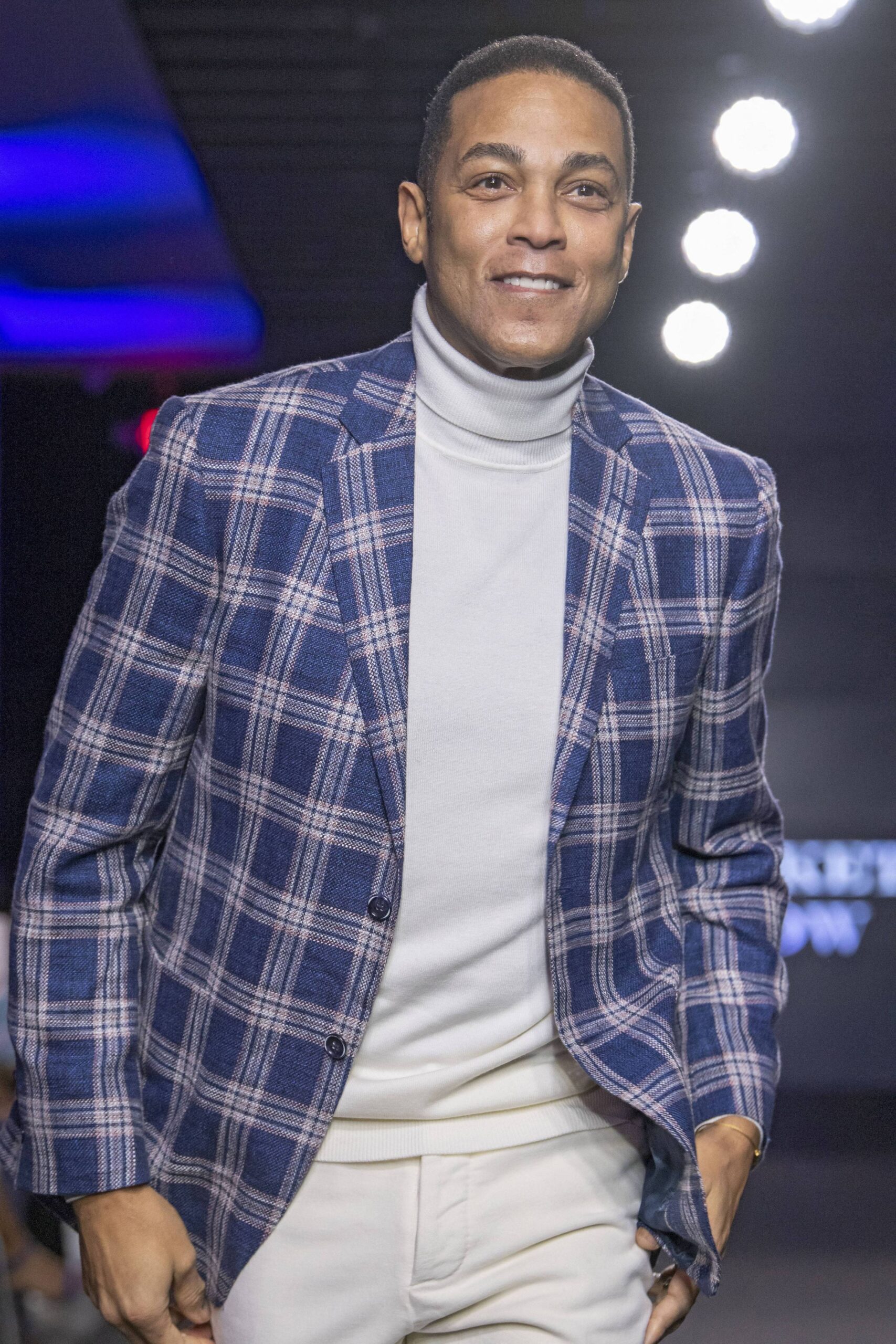 Don Lemon in a blue suit jacket smiling.
