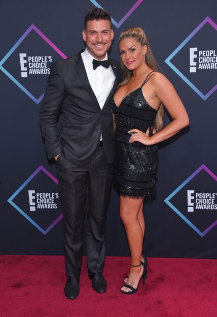 Brittany Cartwright and Jax Taylor posing together on the red carpet.