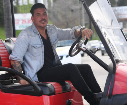 Jax Taylor looking into the camera on a golf cart.