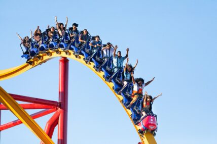 Guests riding a roller coaster