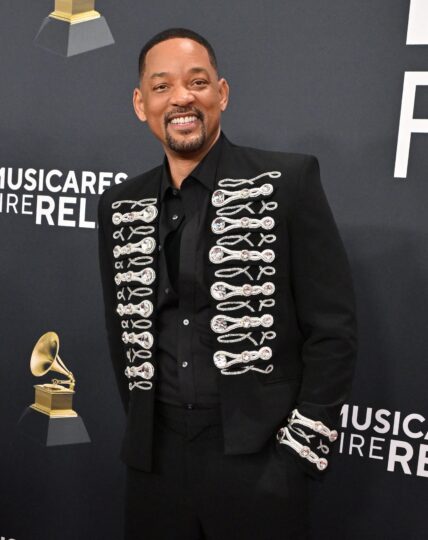 Will Smith posing on the red carpet.