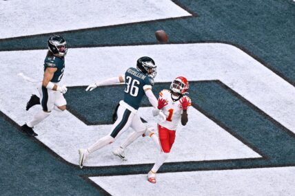 Xavier Worthy catching a football during an NFL game.