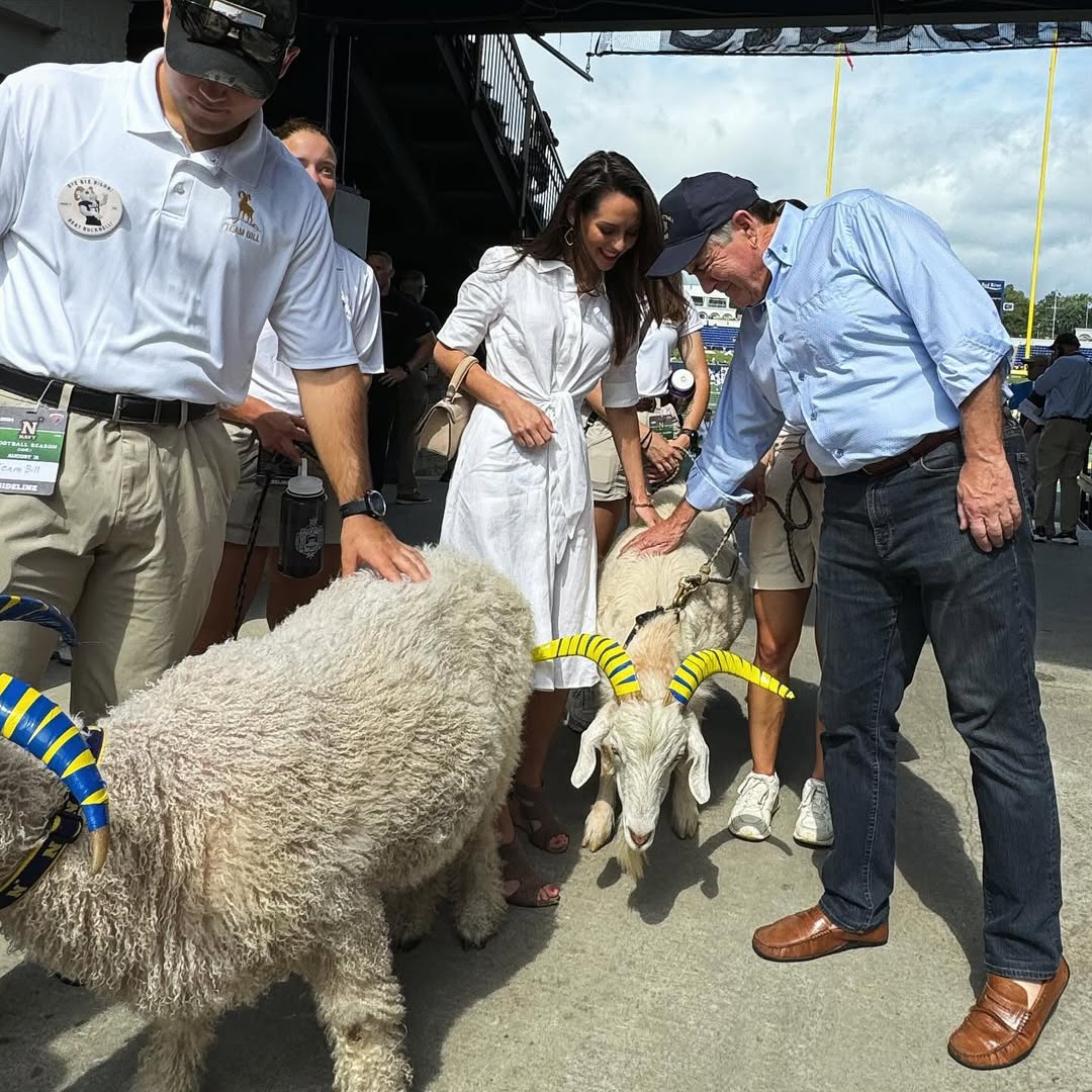 Jordon Hudson and Bill Belichick petting a goat