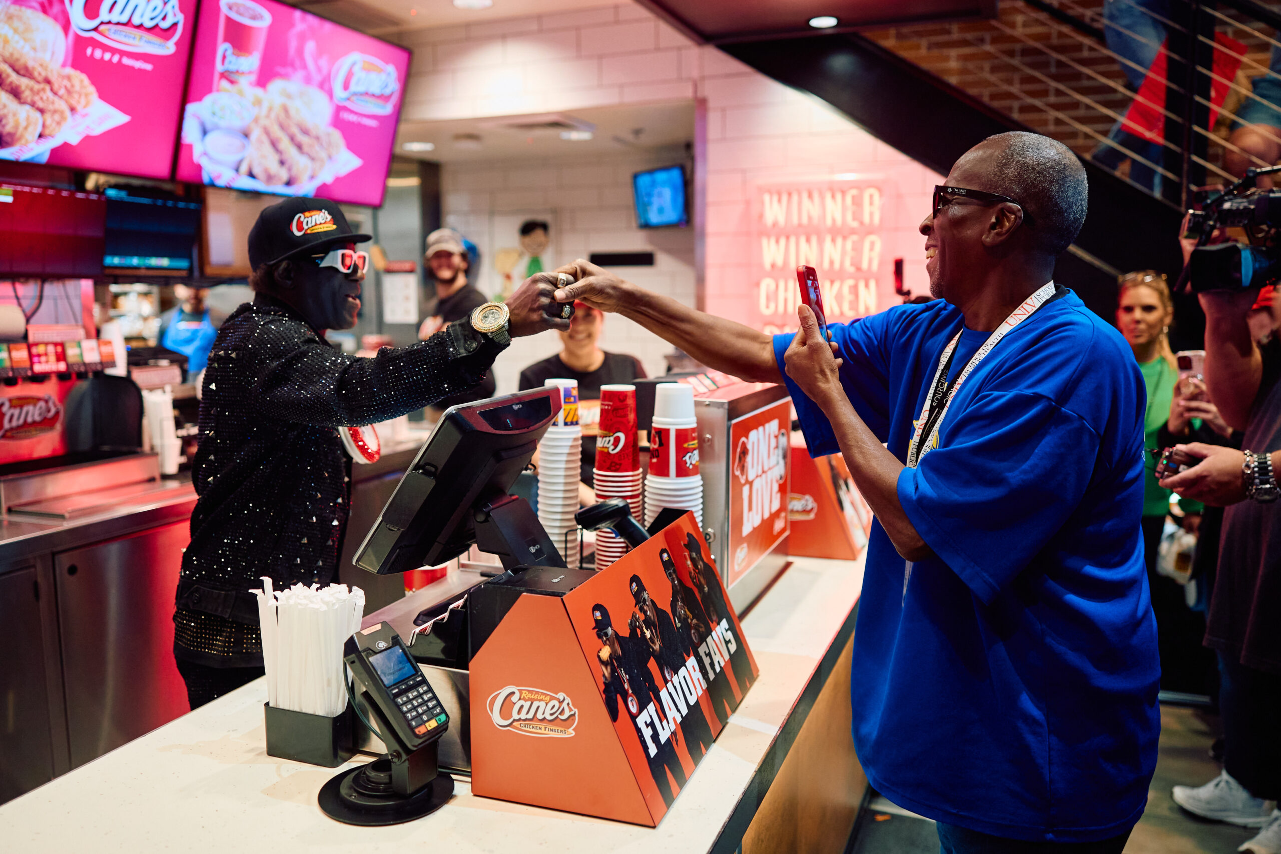 Flavor Flav serving customers at Raising Cane's