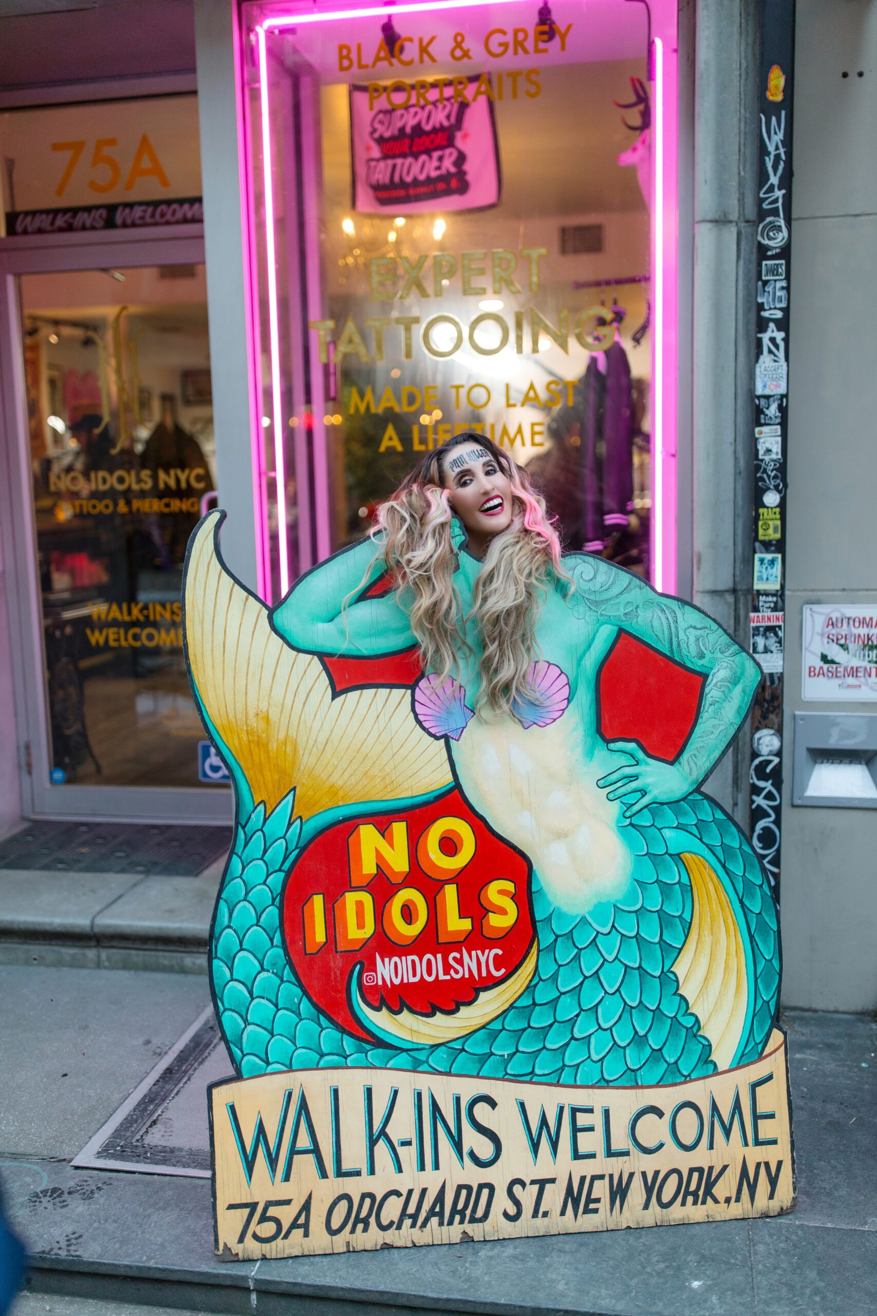 Laura Bryna smiling behind mermaid