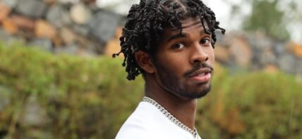 Shedeur Sanders posing in his yard.
