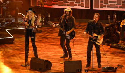FIREROSE, Billy Ray Cyrus and Travis Denning performing on stage