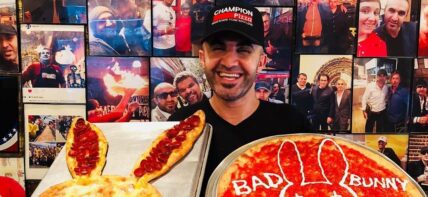 Hakki Akdeniz holding pizza