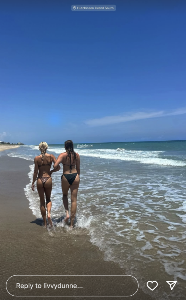 Olivia Dunne links arms with her sister Julz at the beach.