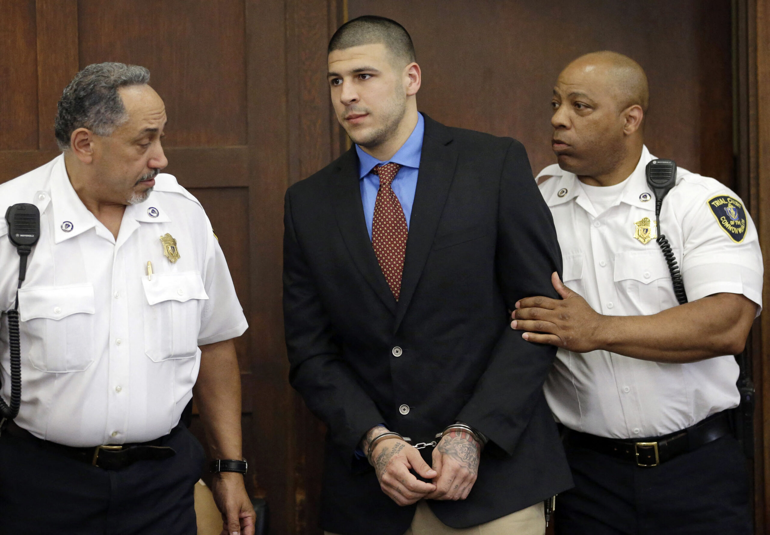 Aaron Hernandez in the court room in handcuffs. 