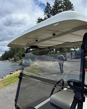 Hailey Bieber walking by a golf cart