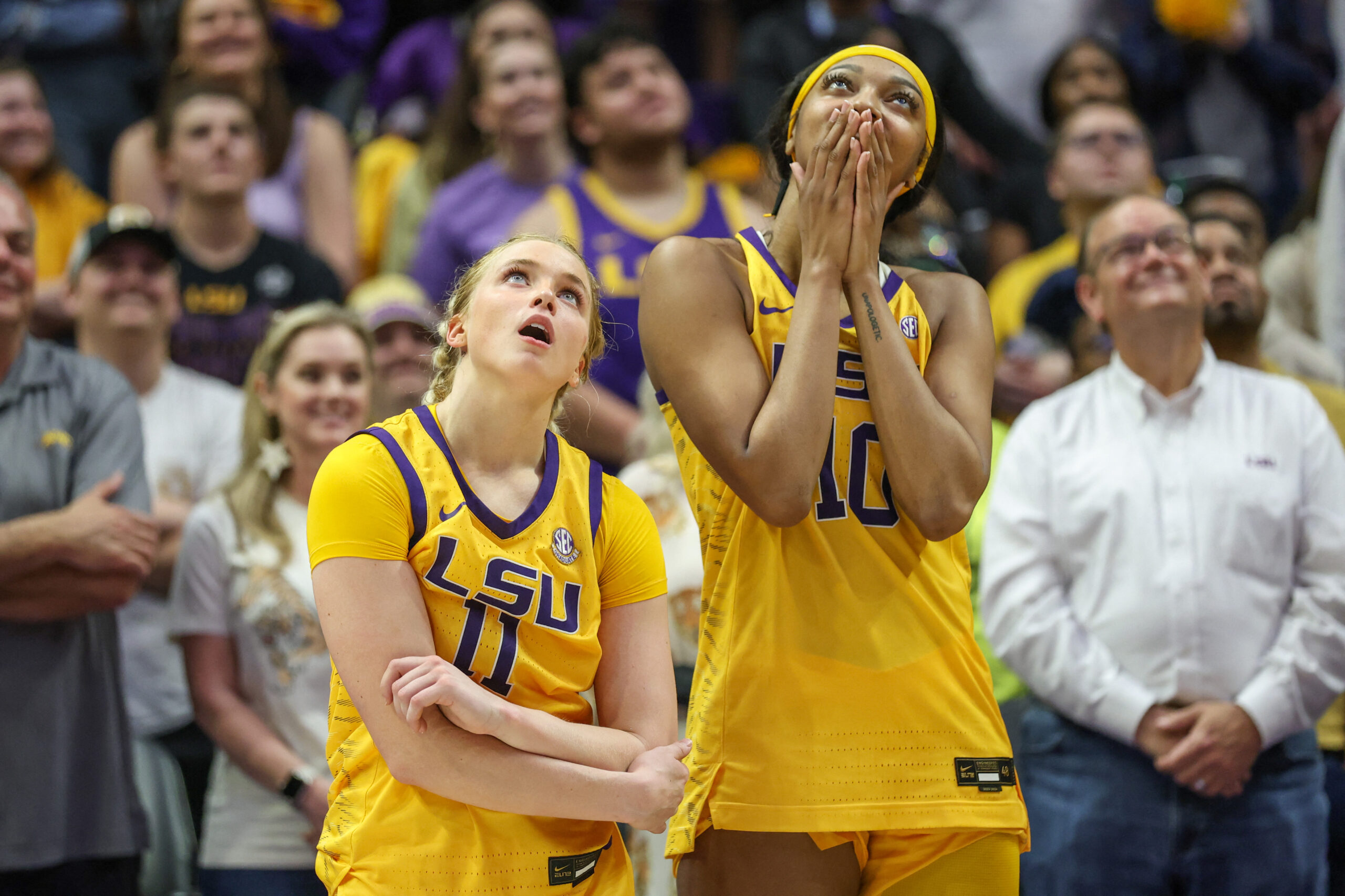 LSU seniors Hailey Van Lith (11) and Angel Reese (10) look up at the video board for a senior tribute video after NCAA Women's Basketball game action between the Kentucky Wildcats and the LSU Tigers at the Pete Maravich Assembly Center in Baton Rouge, LA.