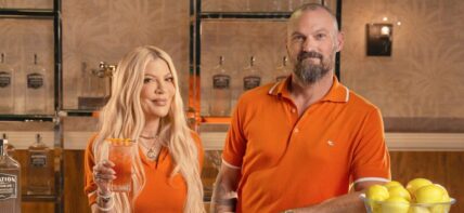 Tori Spelling and Brian Austin Green drinking a cocktail