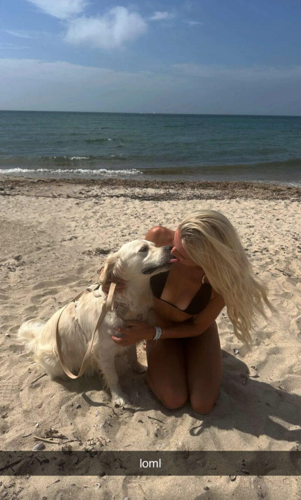 Olivia Dunne poses with her dog.