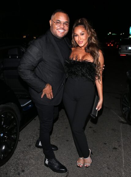 Adrienne Bailon and Israel Houghton posing together for a photo.