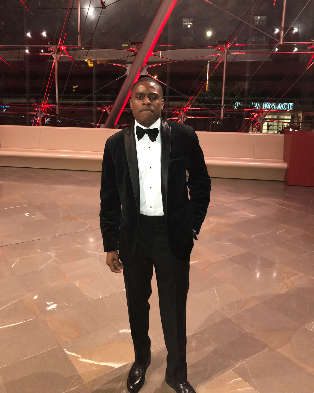 Christian Coleman posing in a suit.
