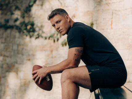 Christian McCaffrey holding a football