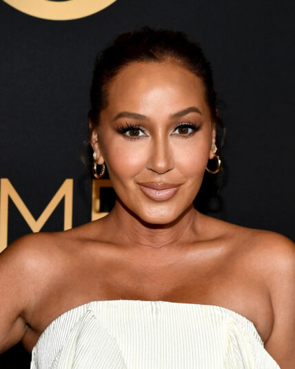 Adrienne Bailon posing for a picture on the red carpet.
