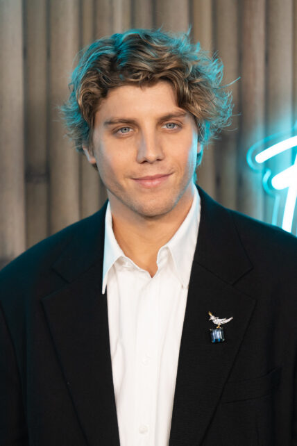 Lukas Gage posing on the red carpet.