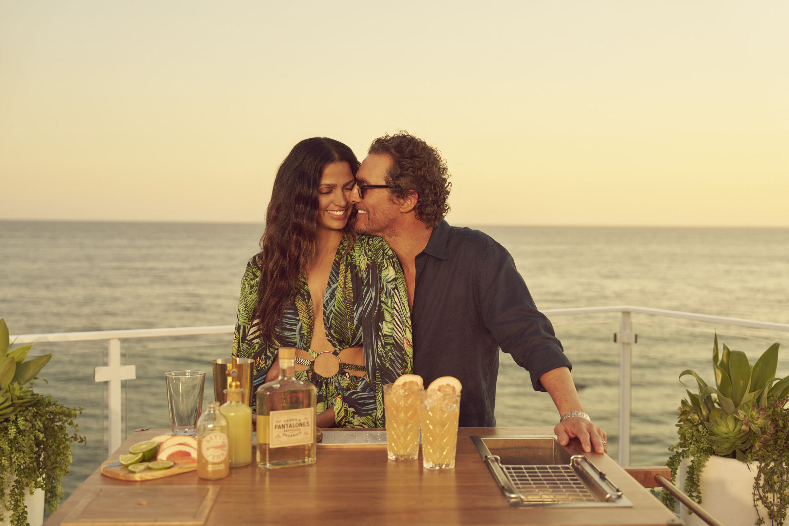 Matthew McConaughey and Camila McConaughey with drinks