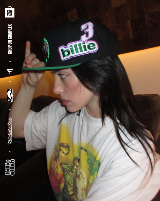 Billie Eilish posing with new NBA hat. 