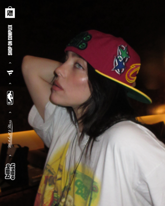Billie Eilish posing with new NBA hat. 