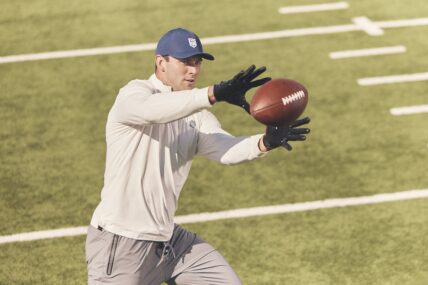 Brock Bowers catching football for Greatness Wins campaign