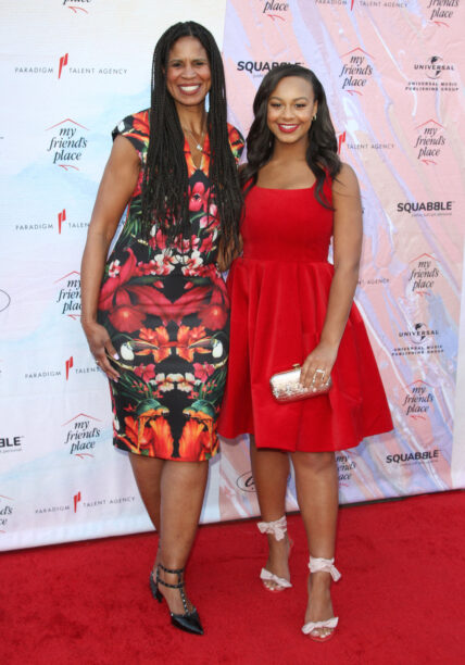 Nia Sioux posing with her mother, Dr. Holly Frazier, on the red carpet.