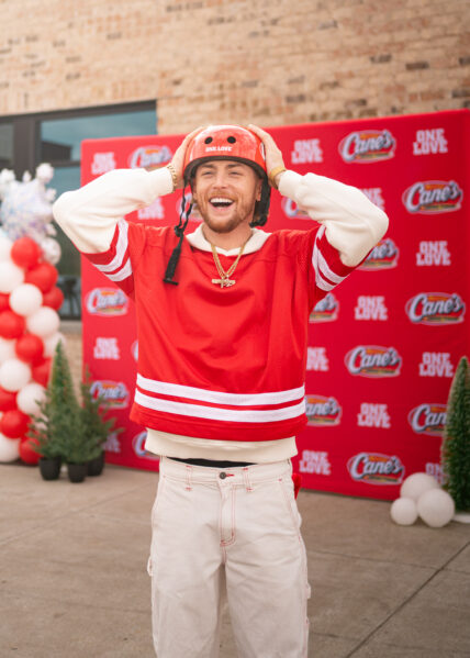 Bailey Zimmerman at Raising Cane's event for bike giveaway