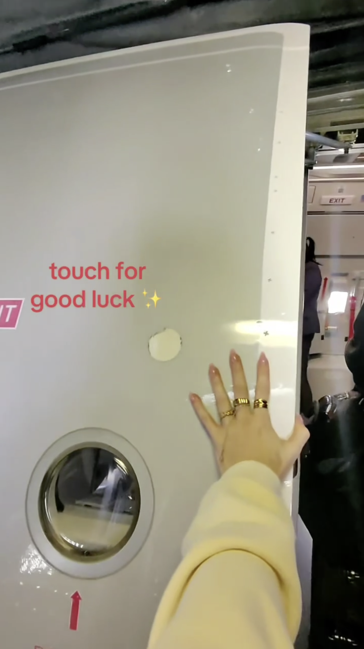 Kay Carlson touching her plane for good luck.