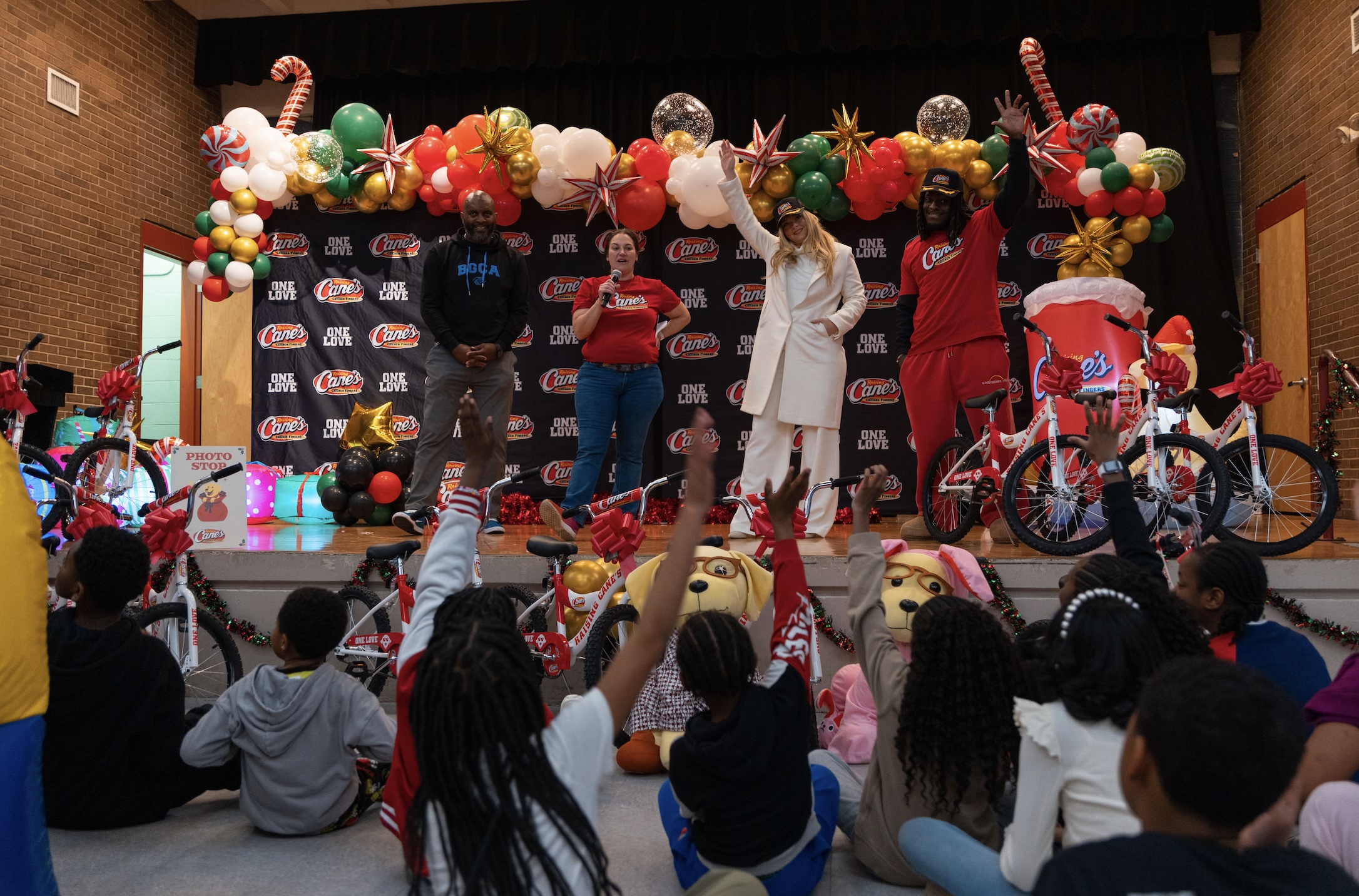 Camille Kostek, D'Ernest Johnson and Raising Cane's members at charity event