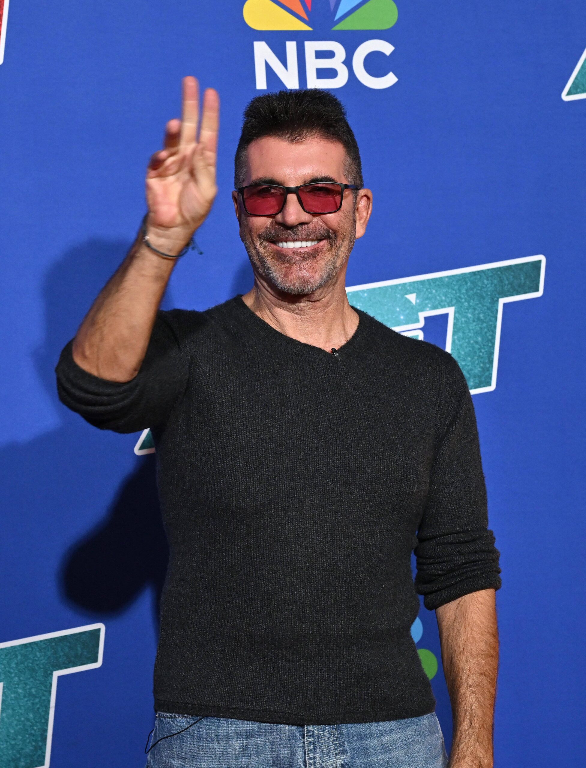 Simon Cowell holding up peace sign at Americas Got Talent Season 20 - Red Carpet