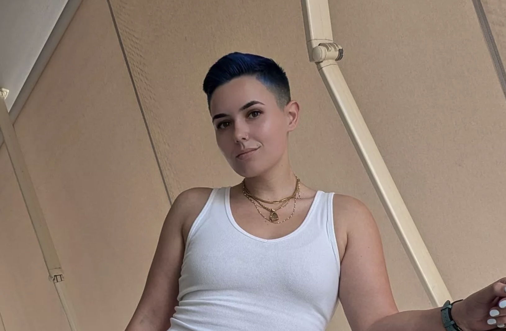 Kit Barrus wearing a white tank top