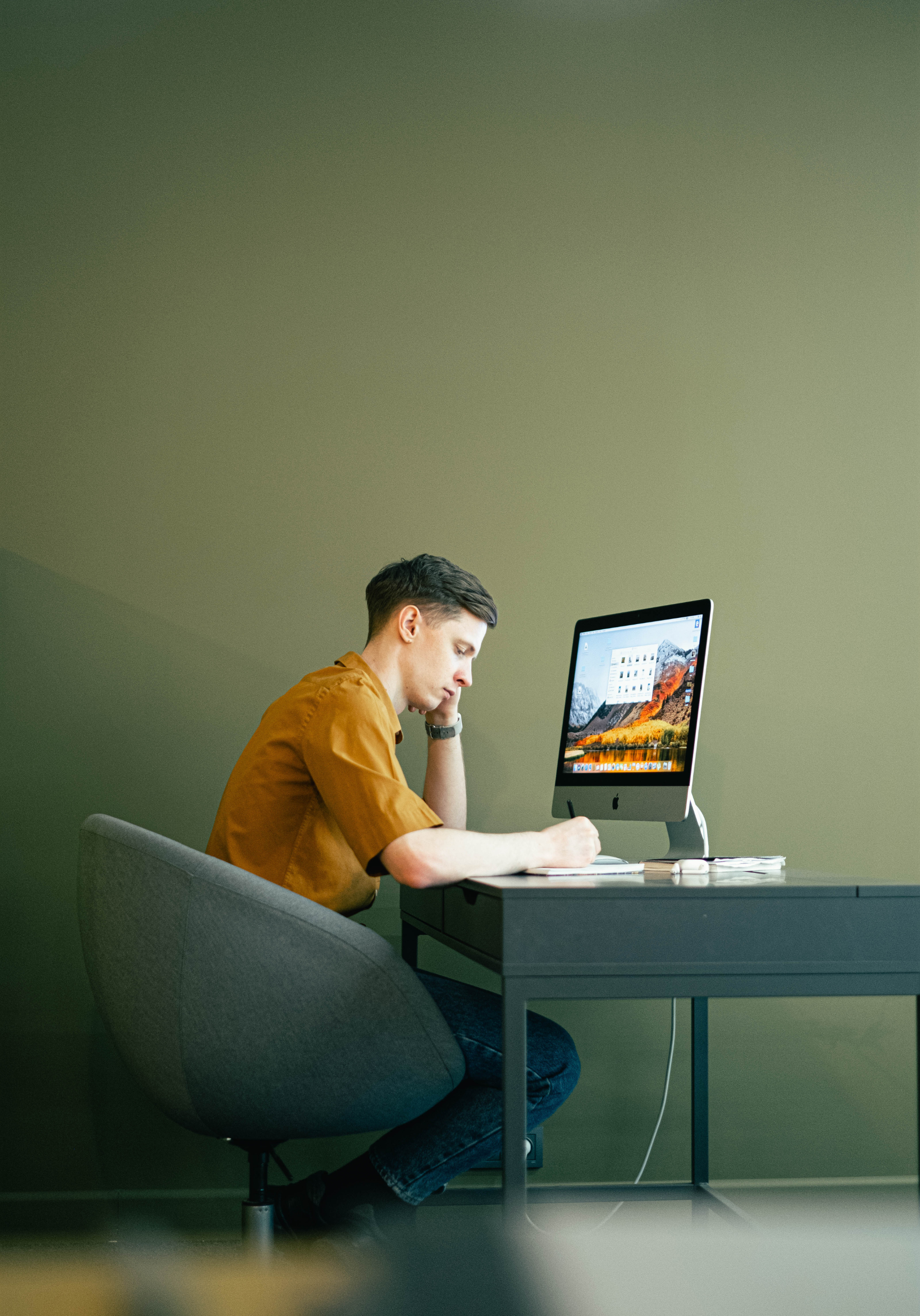 Man sitting at computer looking bored