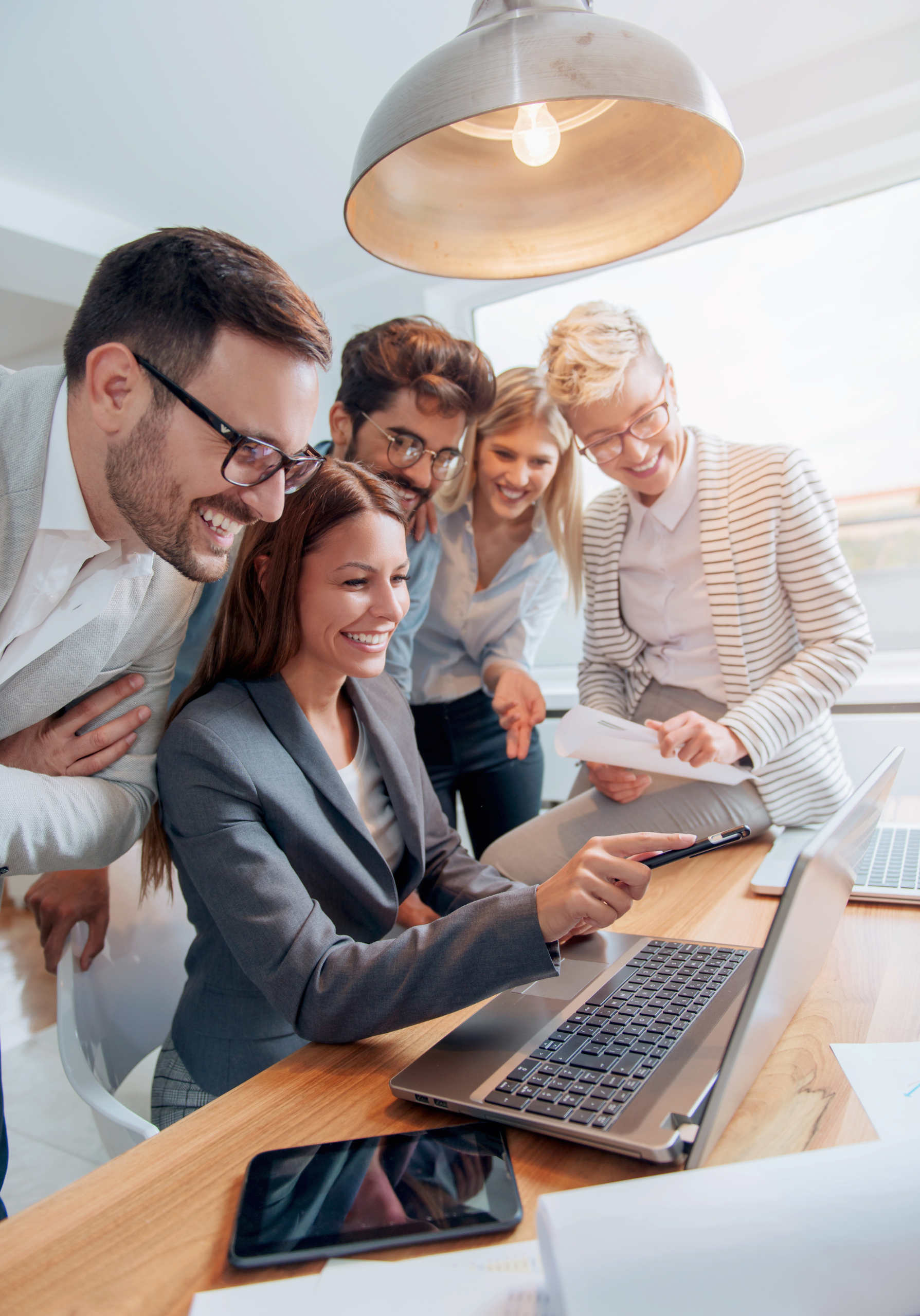 Group of people in front of computer looking happy
