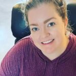 Colleen Hoover sitting in a chair