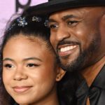Wayne Brady posing on the red carpet with his daughter.