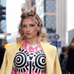 Tina Win wearing colorful dress and yellow jacket