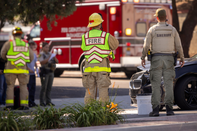 Fire fighter standing in front of fire truck. 
