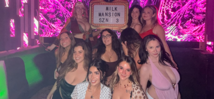 Group of women posing together at a club.