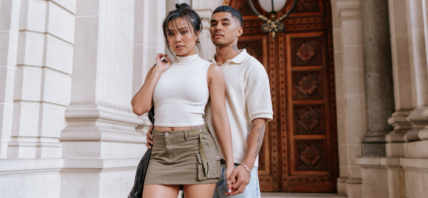 Man and woman holding hands posing for the camera.